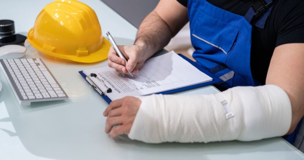 Injured worker signing a form
